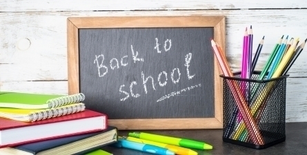 School supplies with chalk board. Text: Back to School